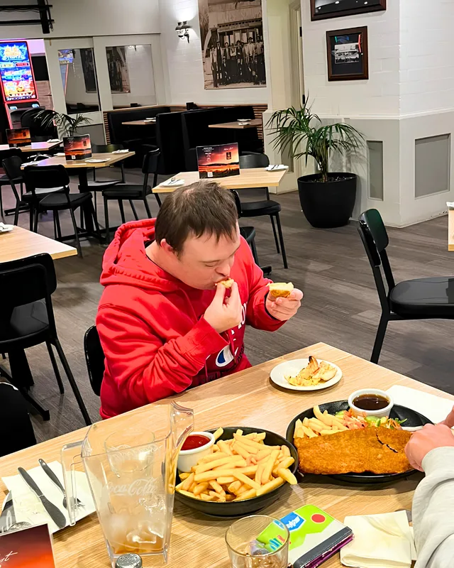 Liam enjoying lunch at a restaurant table.